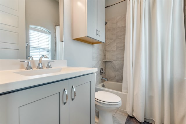 bathroom with tile patterned floors, vanity, toilet, and shower / bath combo with shower curtain