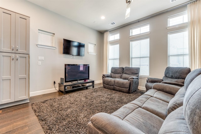 living area with recessed lighting, visible vents, baseboards, and wood finished floors