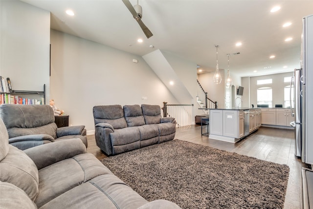 living room with ceiling fan, recessed lighting, visible vents, stairway, and light wood-type flooring