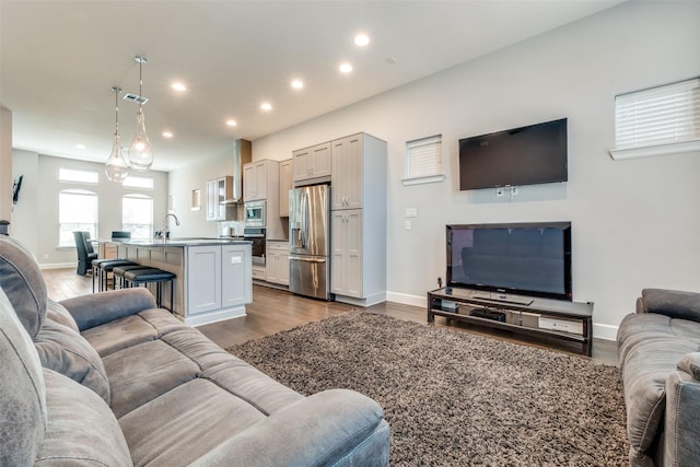 living area featuring dark wood-style floors, visible vents, baseboards, and recessed lighting