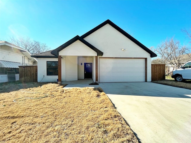 ranch-style home featuring driveway, brick siding, an attached garage, and fence