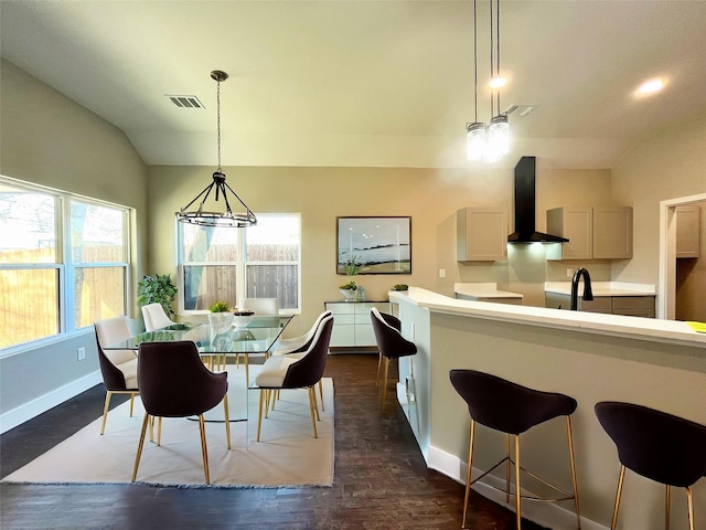 dining space featuring vaulted ceiling, dark wood-style floors, visible vents, and baseboards