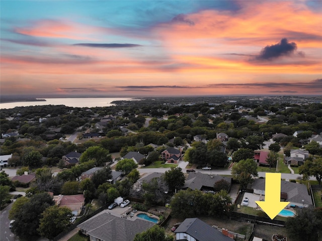 aerial view at dusk with a water view