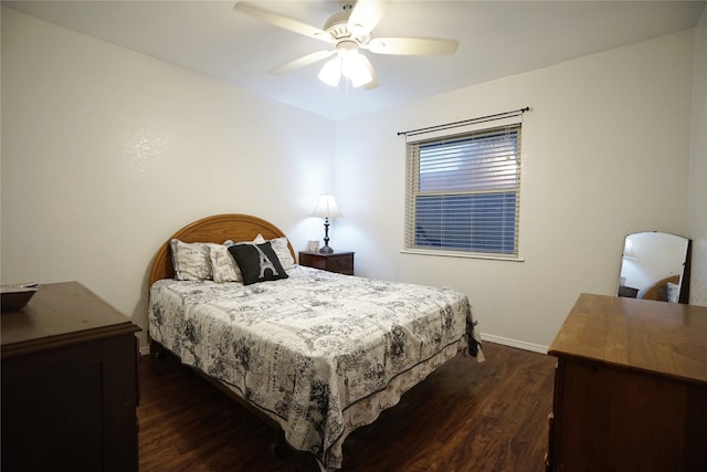 bedroom with dark wood-style floors, ceiling fan, and baseboards