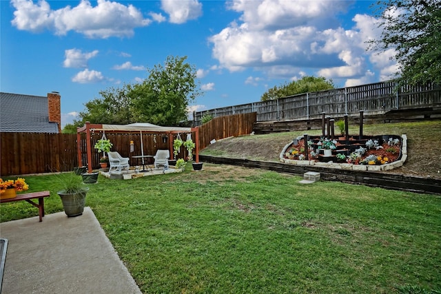 view of yard with a patio area, a fenced backyard, and a garden