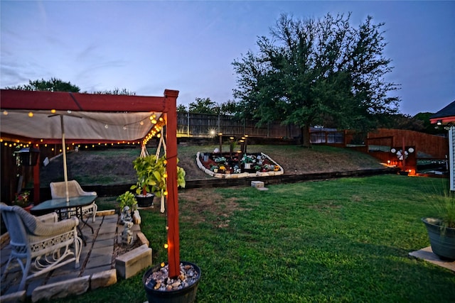 view of yard featuring a fenced backyard, a vegetable garden, and a patio