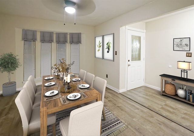 dining area featuring a ceiling fan, baseboards, and wood finished floors