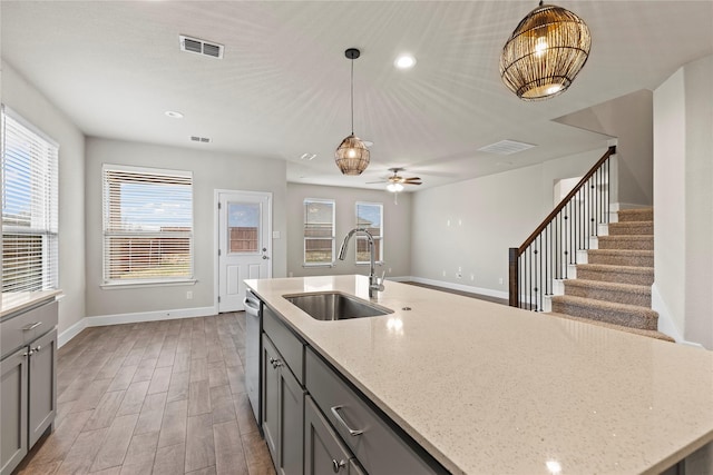 kitchen with a sink, visible vents, and gray cabinetry