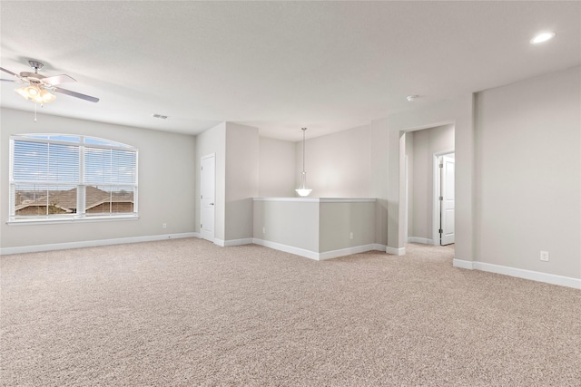 unfurnished room featuring recessed lighting, light colored carpet, visible vents, ceiling fan, and baseboards