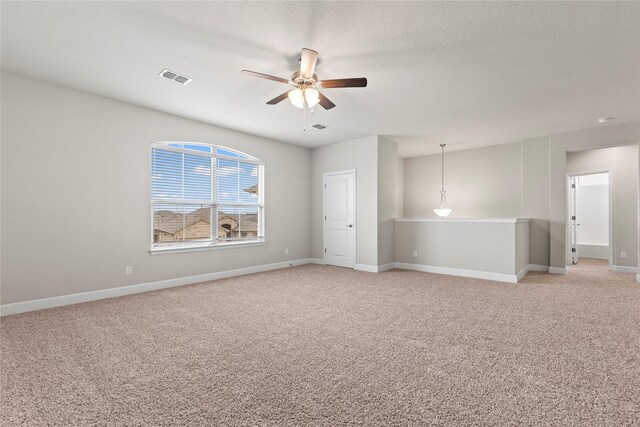 spare room featuring baseboards, visible vents, and light colored carpet