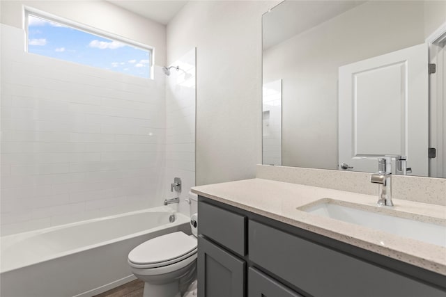 bathroom featuring shower / washtub combination, vanity, and toilet