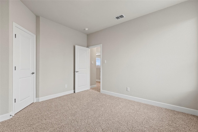 unfurnished bedroom with visible vents, baseboards, and carpet flooring