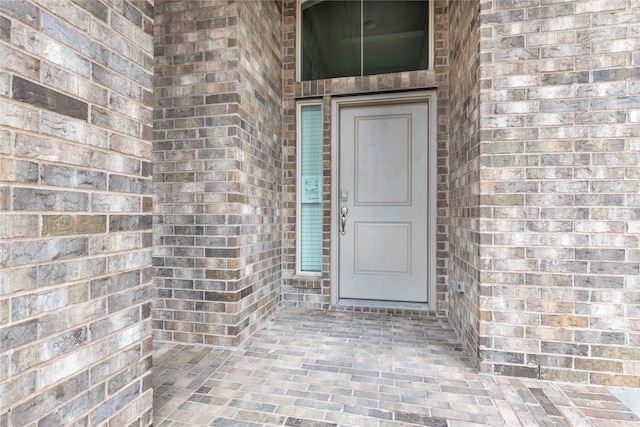 entrance to property with brick siding