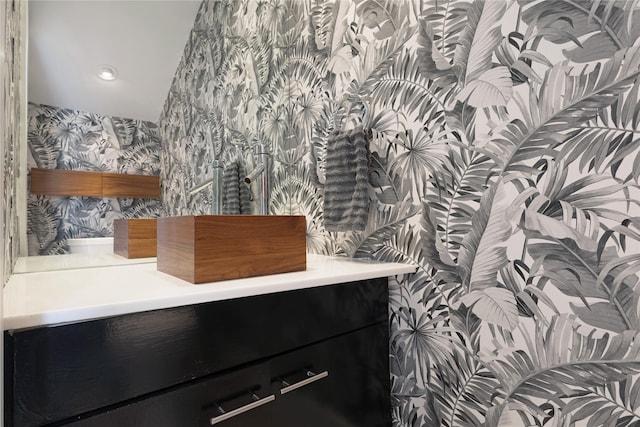 bathroom with recessed lighting, vanity, and wallpapered walls