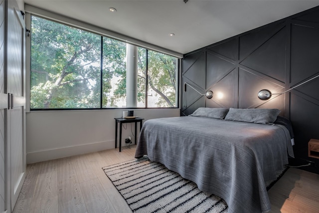 bedroom with light wood-style flooring and baseboards