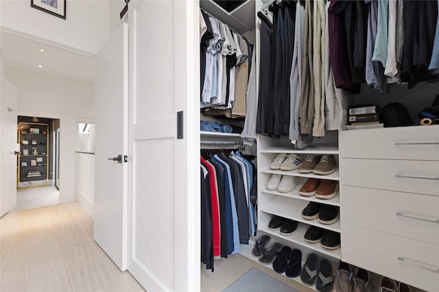 walk in closet with a barn door