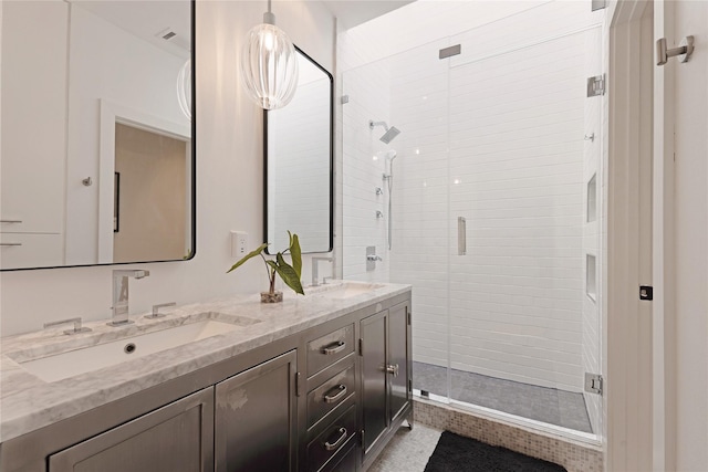 full bathroom with double vanity, a sink, and a shower stall