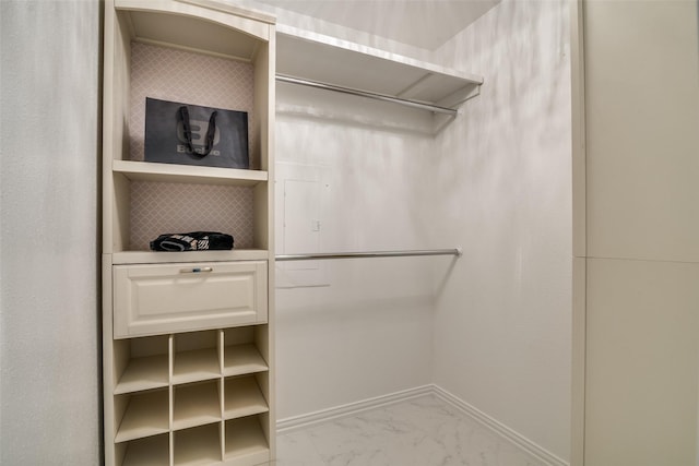 spacious closet with marble finish floor