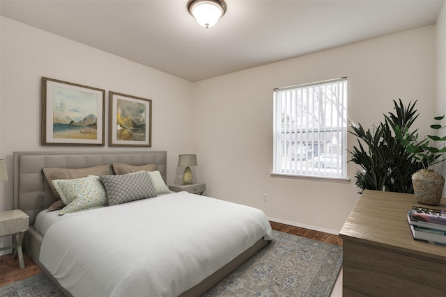 bedroom with dark wood-style flooring and baseboards