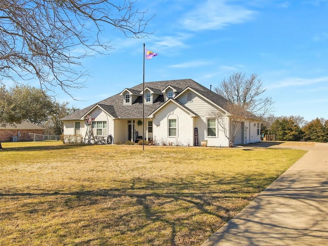 view of front of house with driveway, a garage, fence, and a front lawn