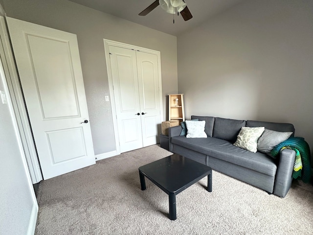 carpeted living room featuring ceiling fan and baseboards