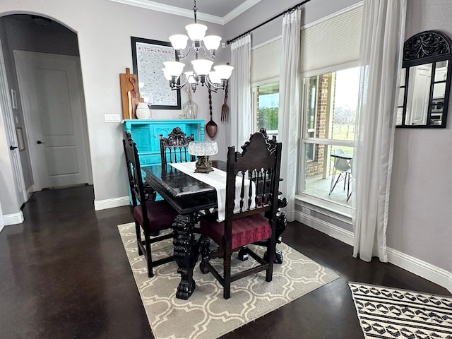 dining space featuring ornamental molding, arched walkways, a chandelier, and baseboards