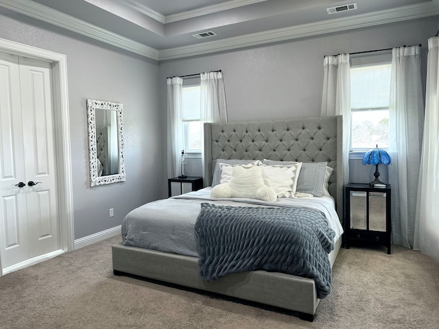 carpeted bedroom featuring visible vents, crown molding, and multiple windows