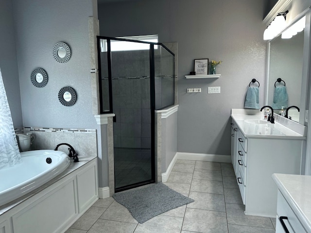 bathroom with tile patterned flooring, a shower stall, vanity, and baseboards