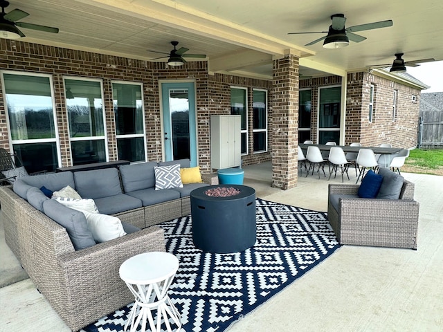 view of patio / terrace with ceiling fan, an outdoor living space, and outdoor dining space