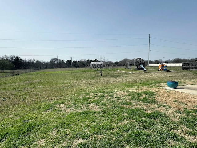 view of yard featuring fence and a playground