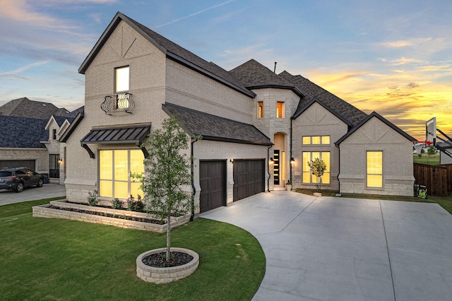 french country style house featuring brick siding, a shingled roof, stone siding, driveway, and a front lawn