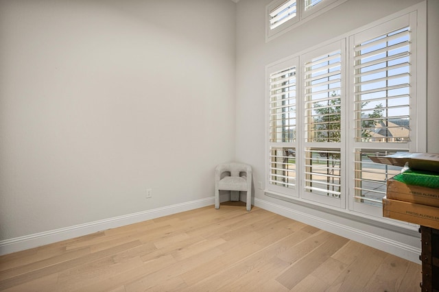 unfurnished room with light wood-style floors and baseboards