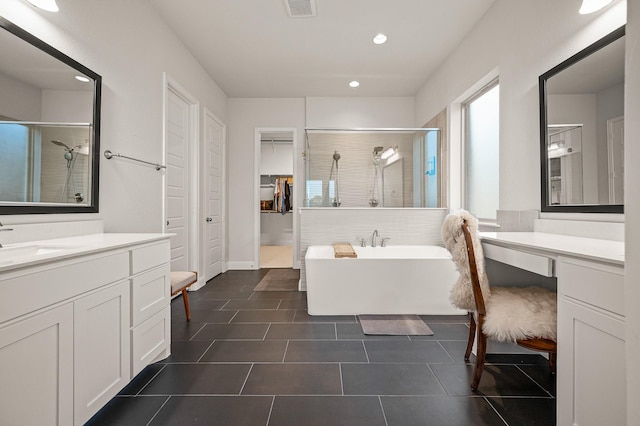 full bath featuring a soaking tub, visible vents, a shower stall, vanity, and tile patterned flooring