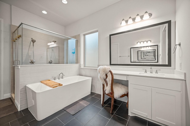 full bath featuring tile patterned flooring, recessed lighting, vanity, a soaking tub, and a shower stall