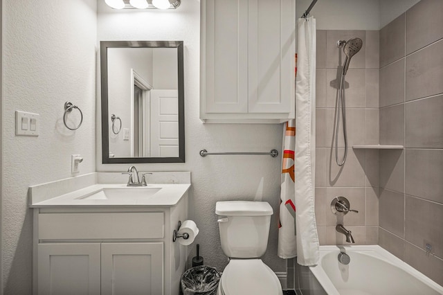 full bath with toilet, a textured wall, shower / tub combo with curtain, and vanity