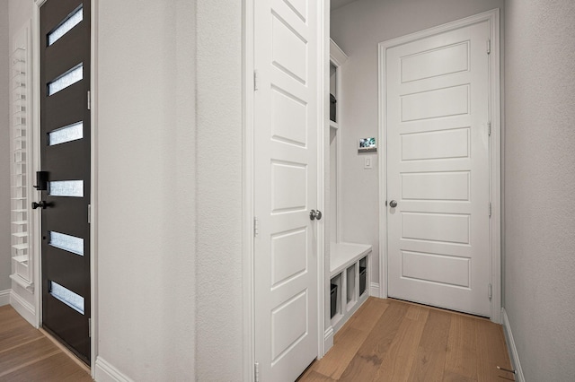 mudroom with light wood-type flooring and baseboards