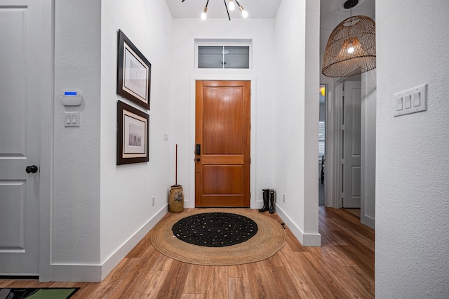 foyer featuring wood finished floors and baseboards