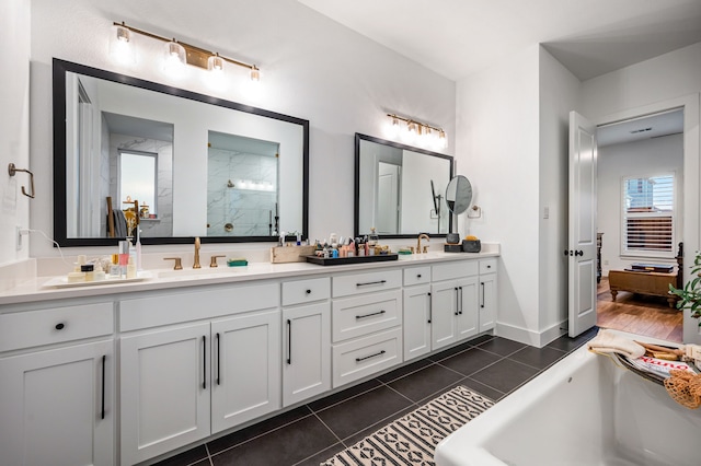 bathroom featuring double vanity, a soaking tub, a sink, tiled shower, and tile patterned floors