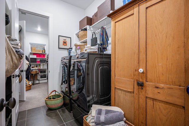 spacious closet with carpet, tile patterned flooring, and washing machine and clothes dryer