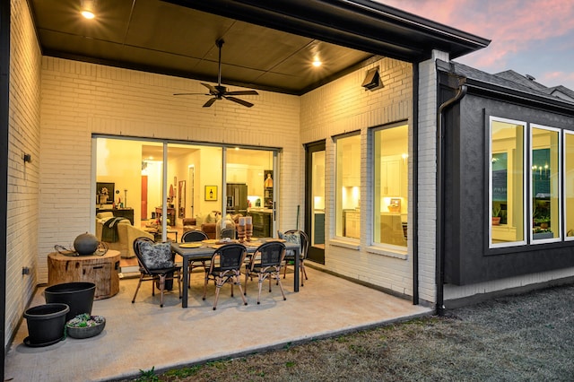 view of patio with outdoor dining space and ceiling fan