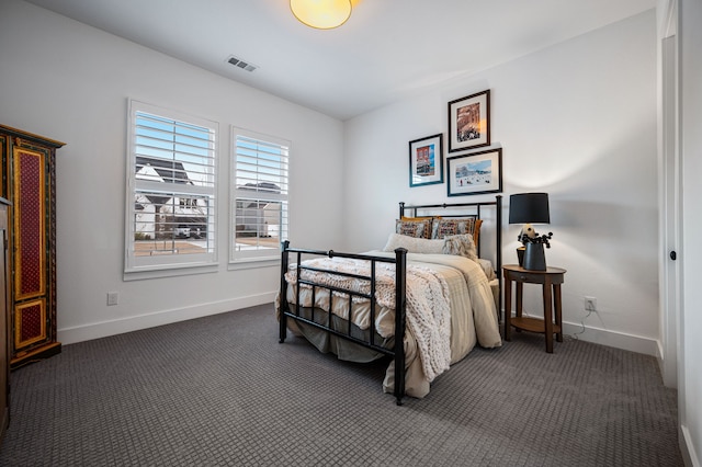 bedroom featuring dark carpet, visible vents, and baseboards