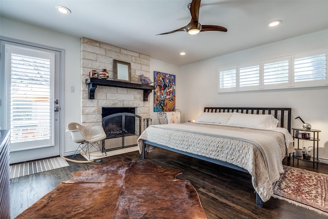 bedroom with recessed lighting, a fireplace, ceiling fan, and wood finished floors