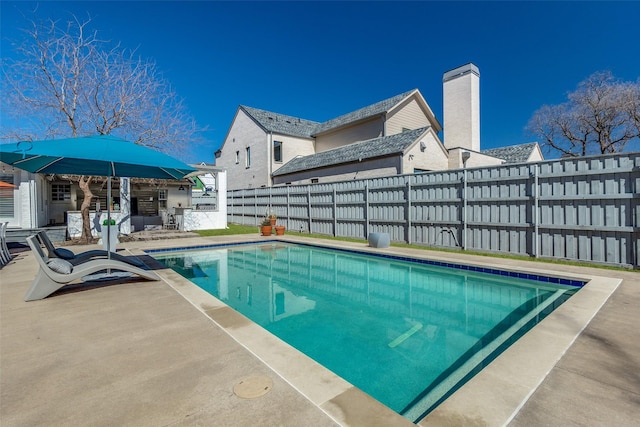 view of swimming pool with a fenced in pool, a patio, and a fenced backyard