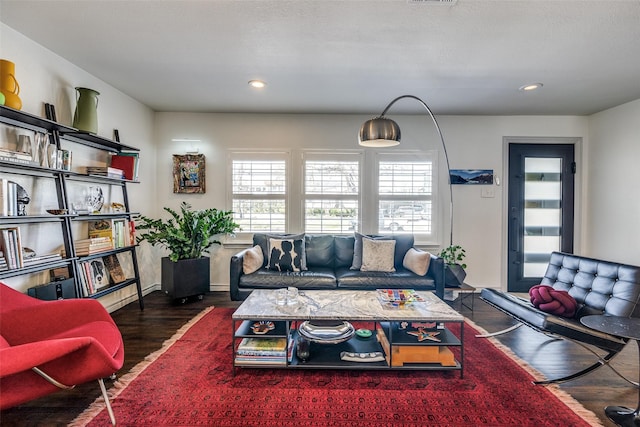 living room with recessed lighting, wood finished floors, and visible vents