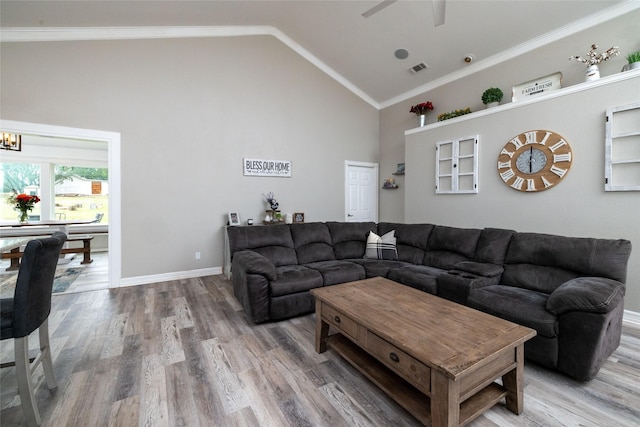 living room featuring high vaulted ceiling, crown molding, visible vents, and wood finished floors