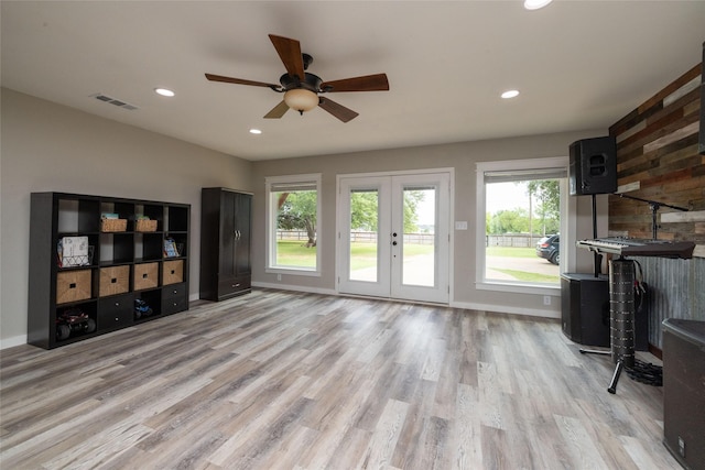 living area featuring visible vents, baseboards, light wood-style flooring, french doors, and recessed lighting