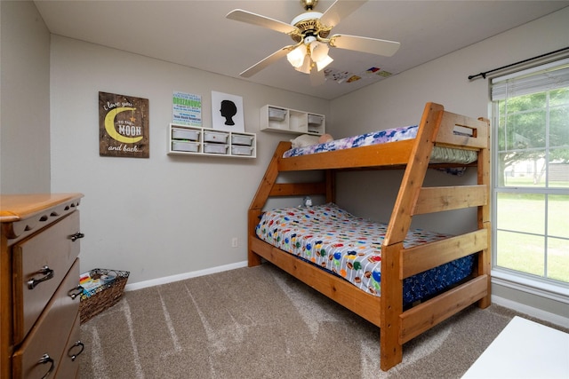 bedroom featuring carpet floors, multiple windows, a ceiling fan, and baseboards