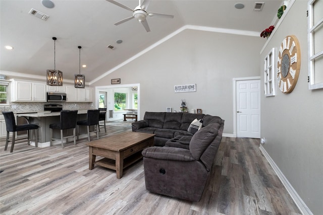 living area featuring light wood-type flooring, visible vents, and baseboards