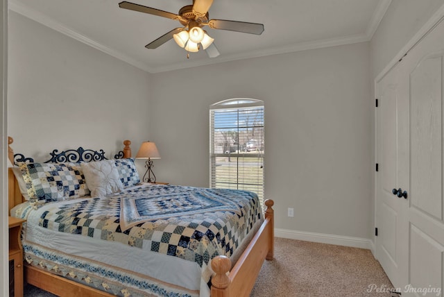 bedroom with ceiling fan, carpet floors, ornamental molding, and baseboards