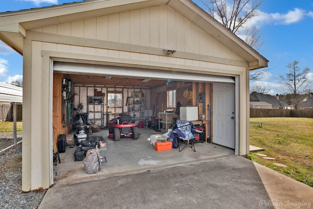 detached garage featuring fence